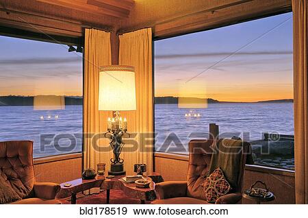 Stock Photo - Windows in modern living room over ocean view. Fotosearch