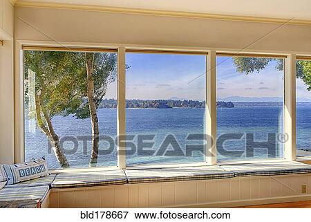 Windows to ocean view in modern living room View Large Photo Image Stock Photo - Windows to ocean view in modern living room. Fotosearch