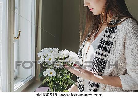 Woman arranging flowers View Large Photo Image Stock Photo - Woman arranging flowers. Fotosearch