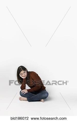 Woman pouting with chin in hand View Large Photo Image Stock Image - Woman pouting with chin in hand. Fotosearch