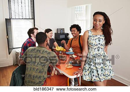 Woman smiling at table with friends View Large Photo Image Stock Photo - Woman smiling at table with friends. Fotosearch