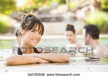 Stock Photo - Woman smiling in swimming pool. Fotosearch