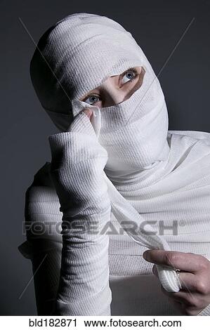 Woman unwrapping mummy costume View Large Photo Image Stock Image - Woman unwrapping mummy costume. Fotosearch