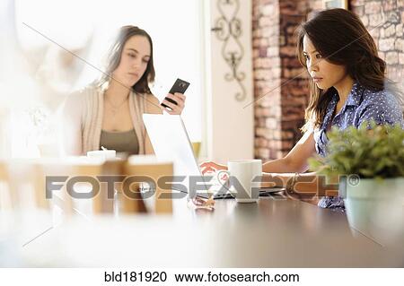 Woman working in coffee shop View Large Photo Image Stock Image - Woman working in coffee shop. Fotosearch