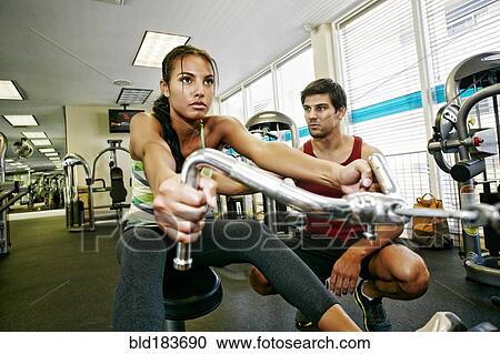 Woman working out with trainer in gymnasium View Large Photo Image Stock Image - Woman working out with trainer in gymnasium. Fotosearch