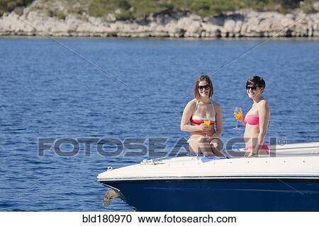 Women drinking cocktails on boat in ocean View Large Photo Image Stock Image - Women drinking cocktails on boat in ocean. Fotosearch