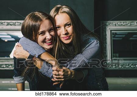 Women hugging in restaurant View Large Photo Image Picture - Women hugging in restaurant. Fotosearch