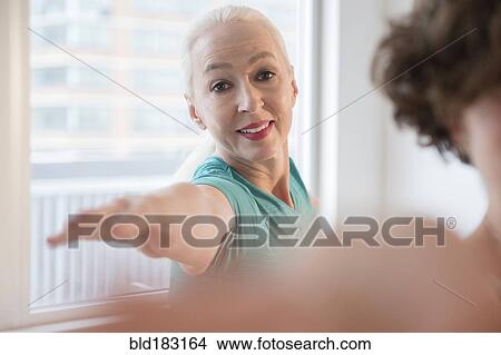 Picture - Women practicing yoga in class. Fotosearch