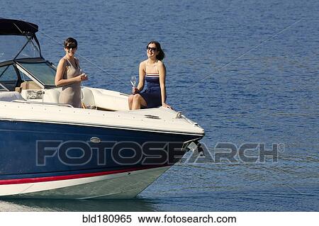 Women smiling on boat in ocean View Large Photo Image Stock Photography - Women smiling on boat in ocean. Fotosearch