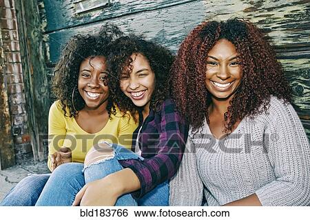 Women smiling outdoors View Large Photo Image Stock Photograph - Women smiling outdoors. Fotosearch