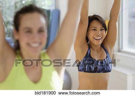 Stock Image - Women taking exercise class. Fotosearch