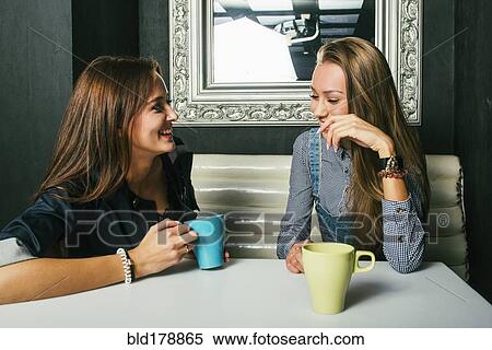 Stock Photography - Women talking in coffee shop. Fotosearch