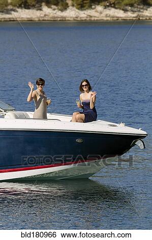 Women waving from boat in ocean View Large Photo Image Stock Photograph - Women waving from boat in ocean. Fotosearch