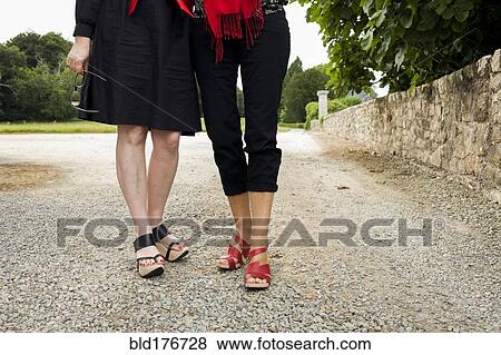 Women wearing sandals on gravel path View Large Photo Image Stock Photo - Women wearing sandals on gravel path. Fotosearch