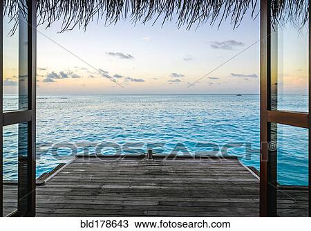 Wooden dock and ocean at sunset View Large Photo Image Stock Image - Wooden dock and ocean at sunset. Fotosearch