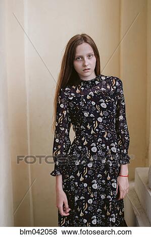 Stock Photo - Serious Caucasian woman wearing dress. Fotosearch