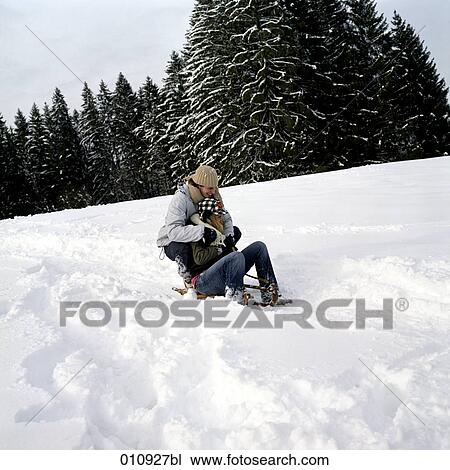 a teenage couple sledging View Large Photo Image Stock Image - a teenage couple sledging. Fotosearch