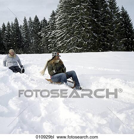 a teenage couple sledging View Large Photo Image Stock Image - a teenage couple sledging. Fotosearch