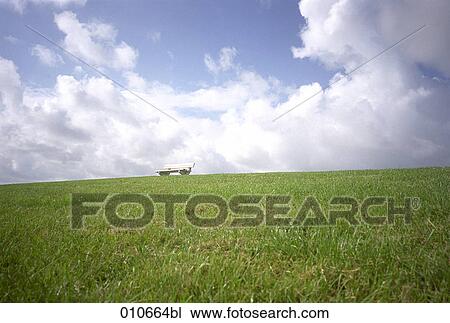Stock Image - bench on a meadow. Fotosearch