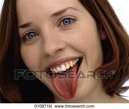 Stock Image - Blue eyed woman showing her tongue. Fotosearch