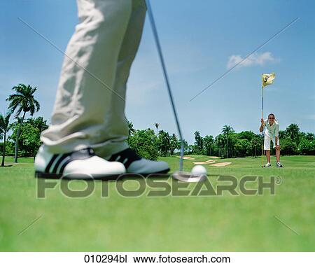 Stock Image - blurred detail shot of a man playing golf. Fotosearch