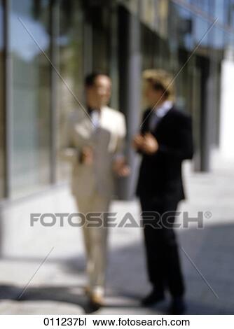 blurred image of two businessmen having a conversation View Large Photo Image Stock Image - blurred image of two businessmen having a conversation. Fotosearch