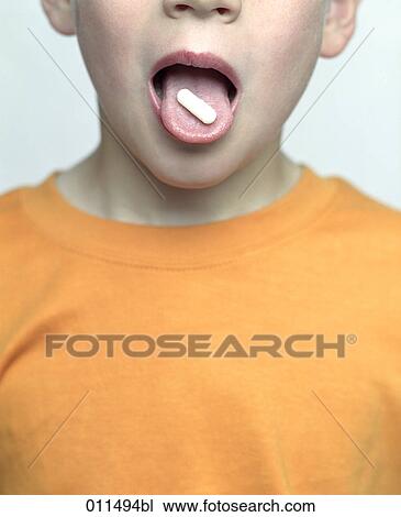 boy opening mouth to show pill on his tongue View Large Photo Image Stock Image - boy opening mouth to show pill on his tongue. Fotosearch