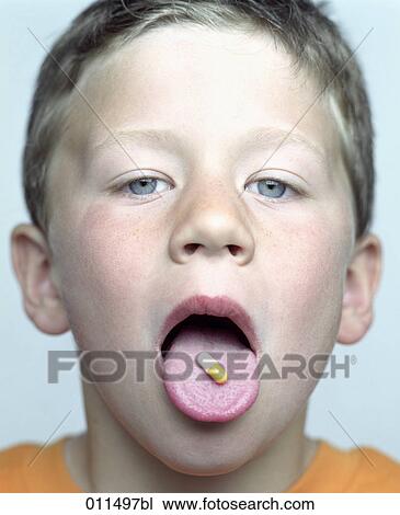 boy showing capsule on his tongue View Large Photo Image Stock Image - boy showing capsule on his tongue. Fotosearch