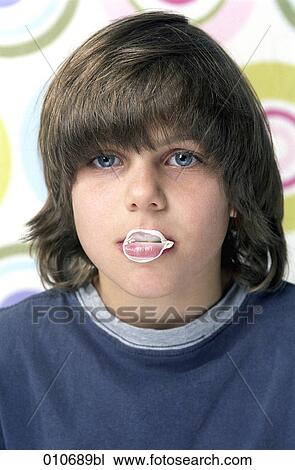 Stock Image - boy with rests of bubblegum on his mouth. Fotosearch