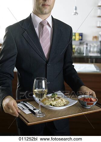 businessman holding a tray with asian food in a self-service restaurant View Large Photo Image Stock Image - businessman holding a tray with asian food in a self-service restaurant. Fotosearch