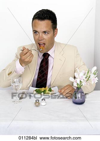 businessman in suit eating View Large Photo Image Stock Image - businessman in suit eating. Fotosearch