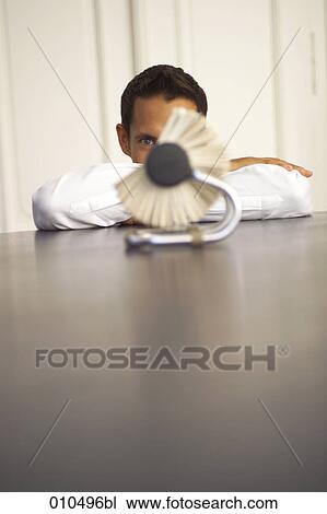 Stock Image - businessman looking at rolodex . Fotosearch