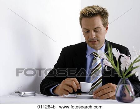 businessman looking thoughtfully at his espresso cup View Large Photo Image Stock Image - businessman looking thoughtfully at his espresso cup. Fotosearch