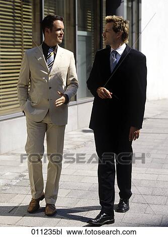 businessman making an explanation to a colleague while walking in the street View Large Photo Image Stock Image - businessman making an explanation to a colleague while walking in the street. Fotosearch