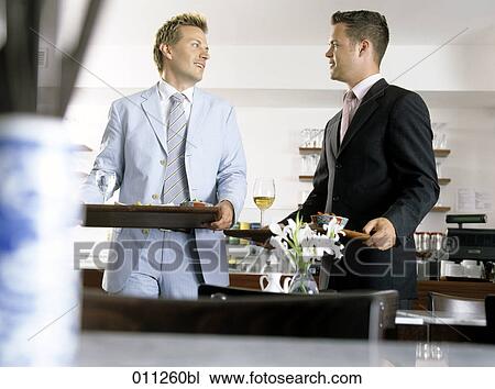 Stock Image - businessmen meeting a restaurant. Fotosearch
