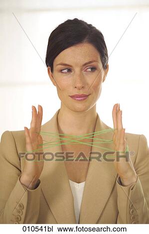 businesswoman doing the cat´s cradle with a green woolen thread View Large Photo Image Stock Image - businesswoman doing the cat´s cradle with a green woolen thread. Fotosearch