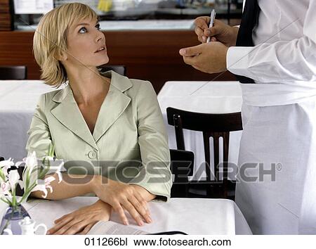 Stock Image - businesswoman ordering in a restaurant. Fotosearch