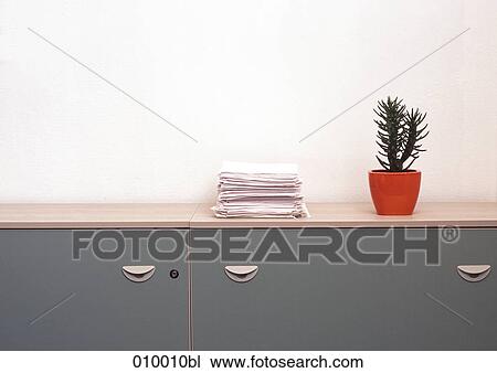 cactus pot on office sideboard with paper stack View Large Photo Image Stock Image - cactus pot on office sideboard with paper stack. Fotosearch