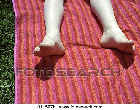 Stock Image - children´s feet on towel. Fotosearch