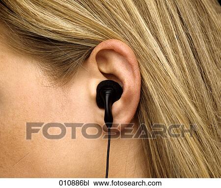 Close-up of ear with earphone View Large Photo Image Stock Image - Close-up of ear with earphone. Fotosearch