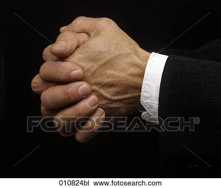 Stock Image - Close-up of folded hands. Fotosearch