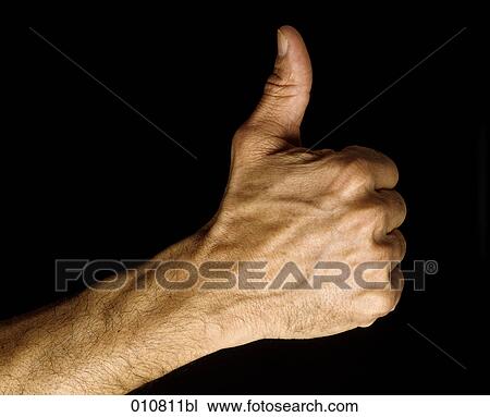 Stock Image - Close-up of male hand doing the thumbs up sign. Fotosearch