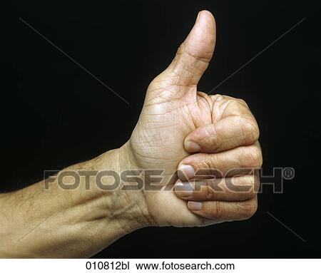 Stock Image - Close-up of male hand doing the thumbs up sign. Fotosearch