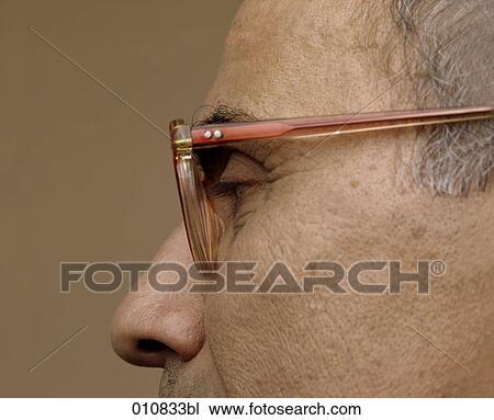 Close-up of mature man wearing horn-rimmed glasses View Large Photo Image Stock Image - Close-up of mature man wearing horn-rimmed glasses. Fotosearch