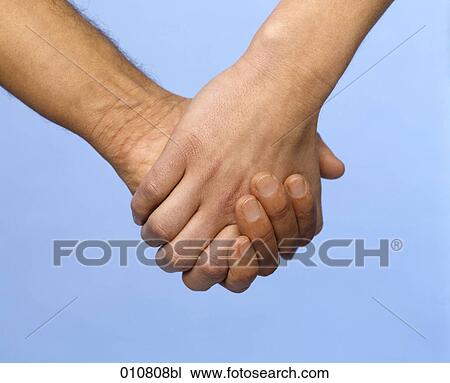 Close-up of two hands holding each other View Large Photo Image Stock Image - Close-up of two hands holding each other. Fotosearch