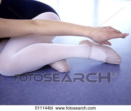 Stock Image - Close-up of young ballet dancer´s arm and legs. Fotosearch