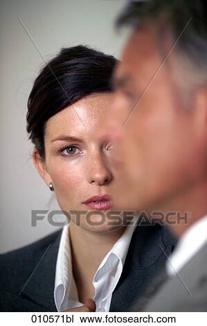 close-up of young businesswoman looking at colleague View Large Photo Image Stock Image - close-up of young businesswoman looking at colleague. Fotosearch