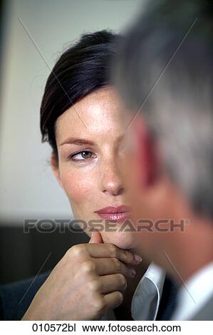 close-up of young businesswoman looking at colleague View Large Photo Image Stock Image - close-up of young businesswoman looking at colleague. Fotosearch