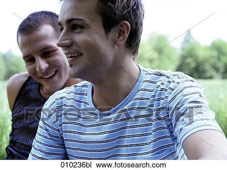 close-up of young gay man (20-25 years) his partner in the background View Large Photo Image Stock Image - close-up of young gay man (20-25 years) his partner in the background. Fotosearch