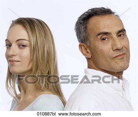 close-up portrait of mature man and young woman back to back View Large Photo Image Stock Image - close-up portrait of mature man and young woman back to back. Fotosearch